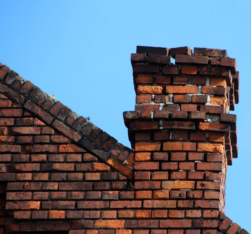 Damaged chimney on an Los Alamitos home showing cracks and missing mortar